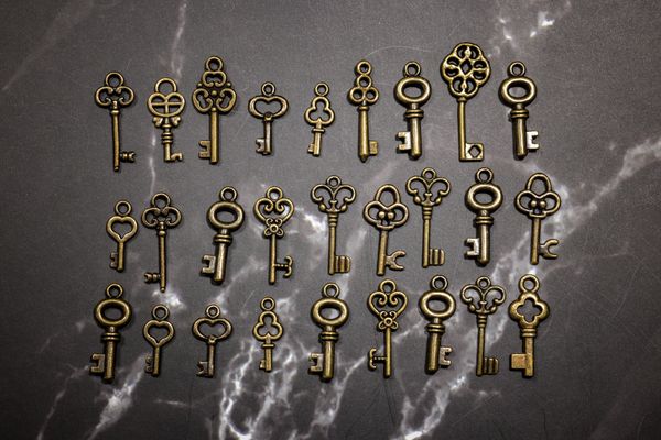 Antique skeleton keys laid out on marble
