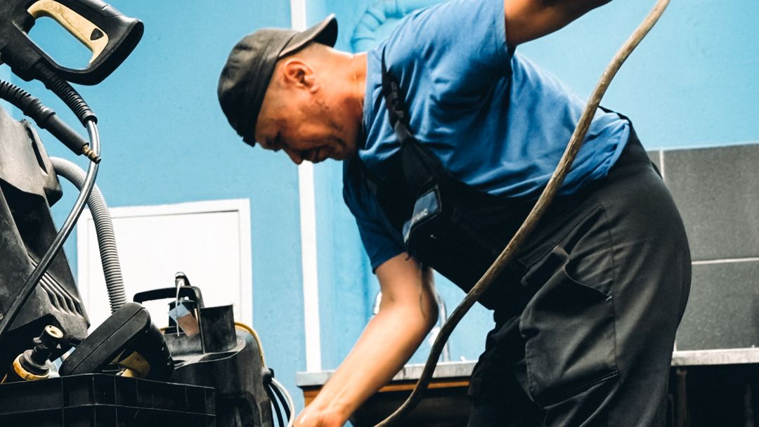 A technician inspecting equipment indoors