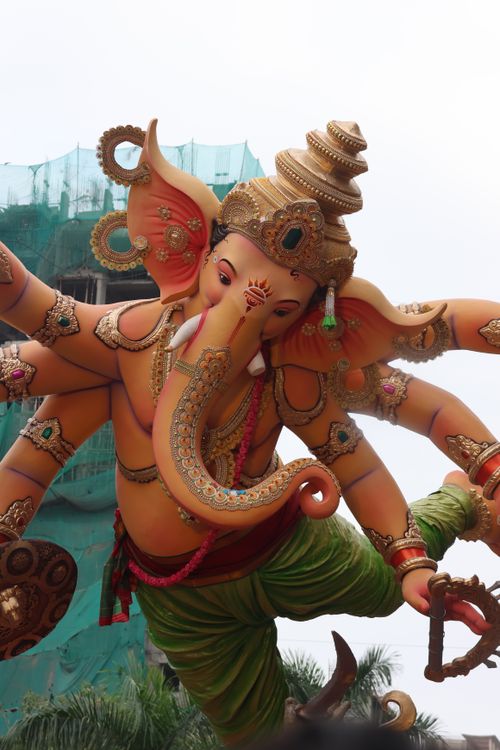 Free Statue of Lord Ganesha with vibrant colors and detailed decorations outdoors. Stock Photo