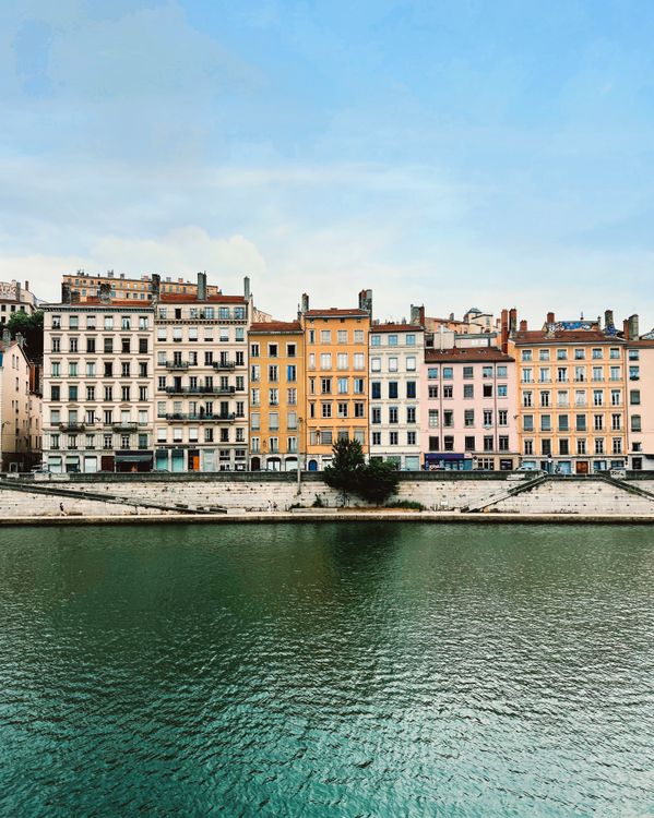 Iconic Riverside Building Colorful Riverside Buildings in Lyon, France · Free Stock Photo