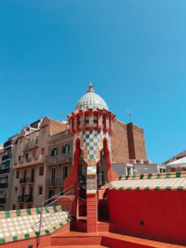 Colorful tower in a cityscape, showcasing unique architectural style and vibrant colors.