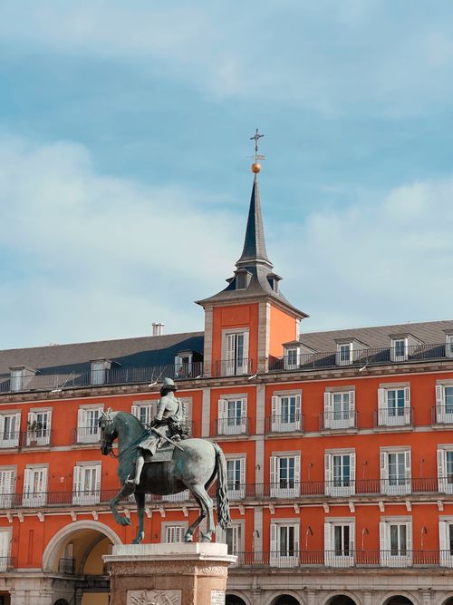 Free Equestrian statue of Philip III in vibrant Plaza Mayor, Madrid, Spain. Stock Photo
