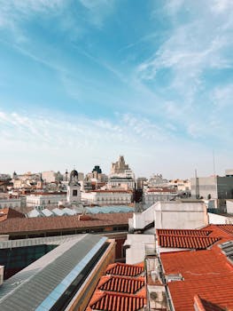Charming view over Madrid's rooftops highlighting classic architecture under a clear blue sky.