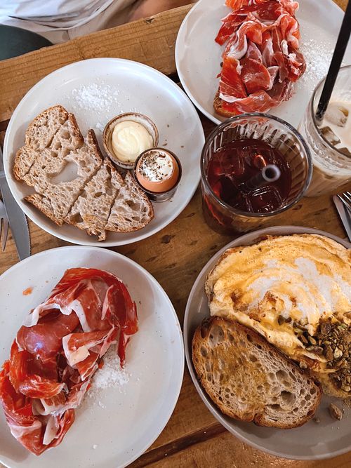 Free Delicious rustic breakfast with cured meats and fresh bread. Perfect for food enthusiasts. Stock Photo