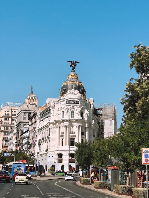 Free Beautiful view of Metropolis Building in Madrid with clear blue sky and street scene. Stock Photo