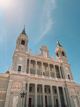 Magnificent view of Almudena Cathedral under a clear blue sky in Madrid.