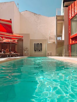 Relax by the rooftop pool of UNO Hotel Madrid on a sunny day.