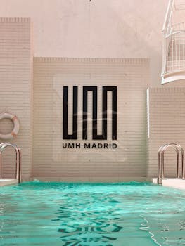 Inviting pool area at UMH Madrid with turquoise waters and sleek modern design.