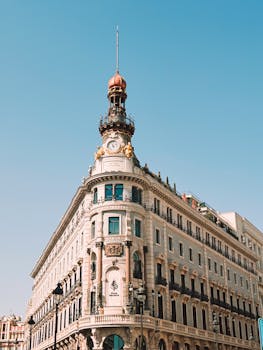 Historic building with ornate architecture and clock tower in bright daylight.