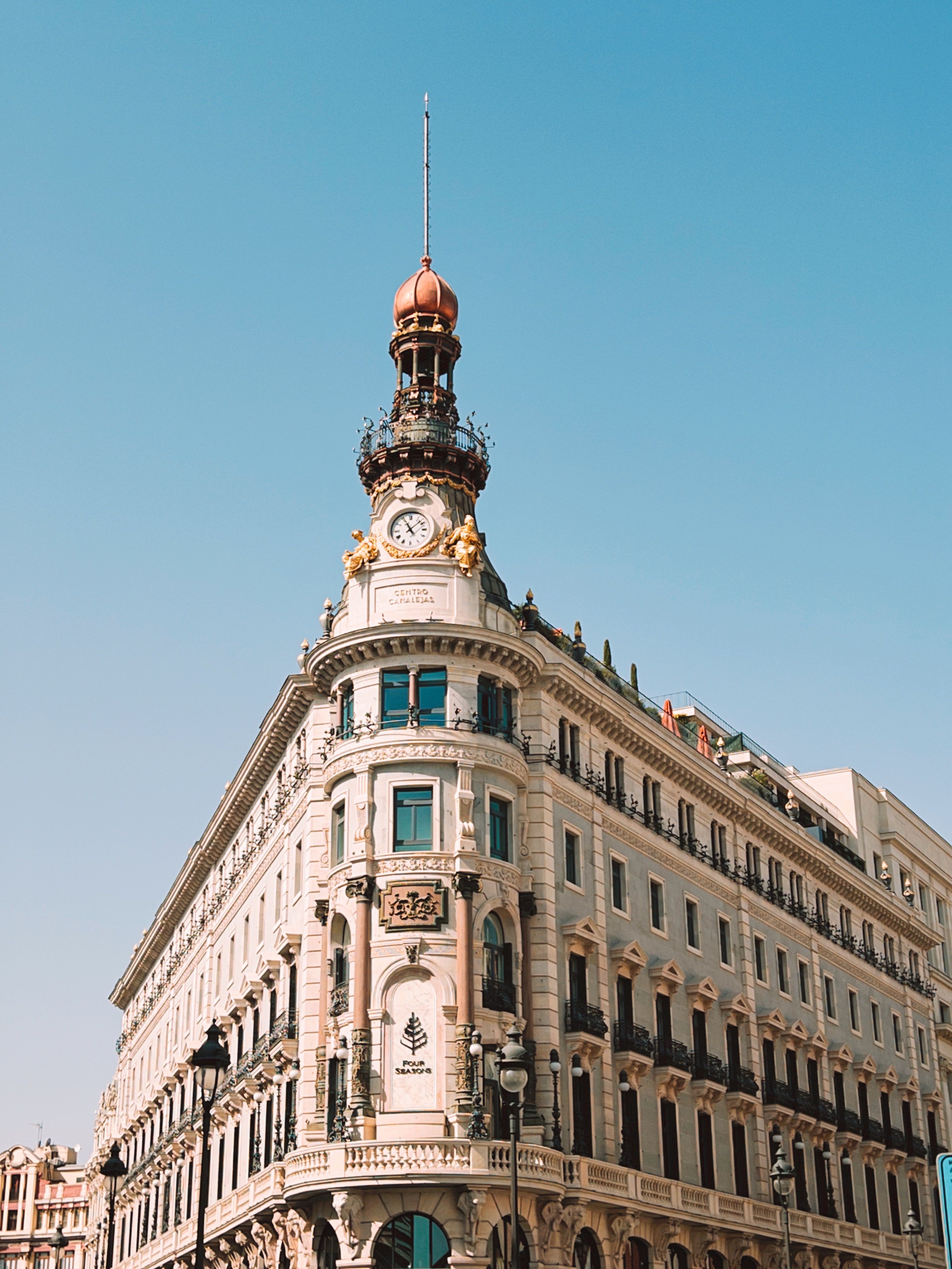 Ornate Building Facade with Tower and Clock · Free Stock Photo