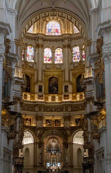 Architectural masterpiece showcasing a grand cathedral interior with stunning stained glass windows and intricate details.