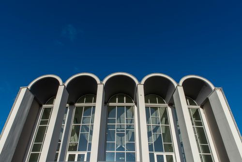Free Architectural facade with arches, modern design against a clear blue sky in Limburg, Netherlands. Stock Photo