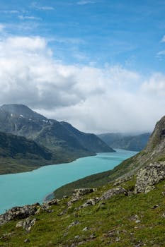 Breathtaking view of turquoise lake and mountains in Jotunheimen National Park, Norway.