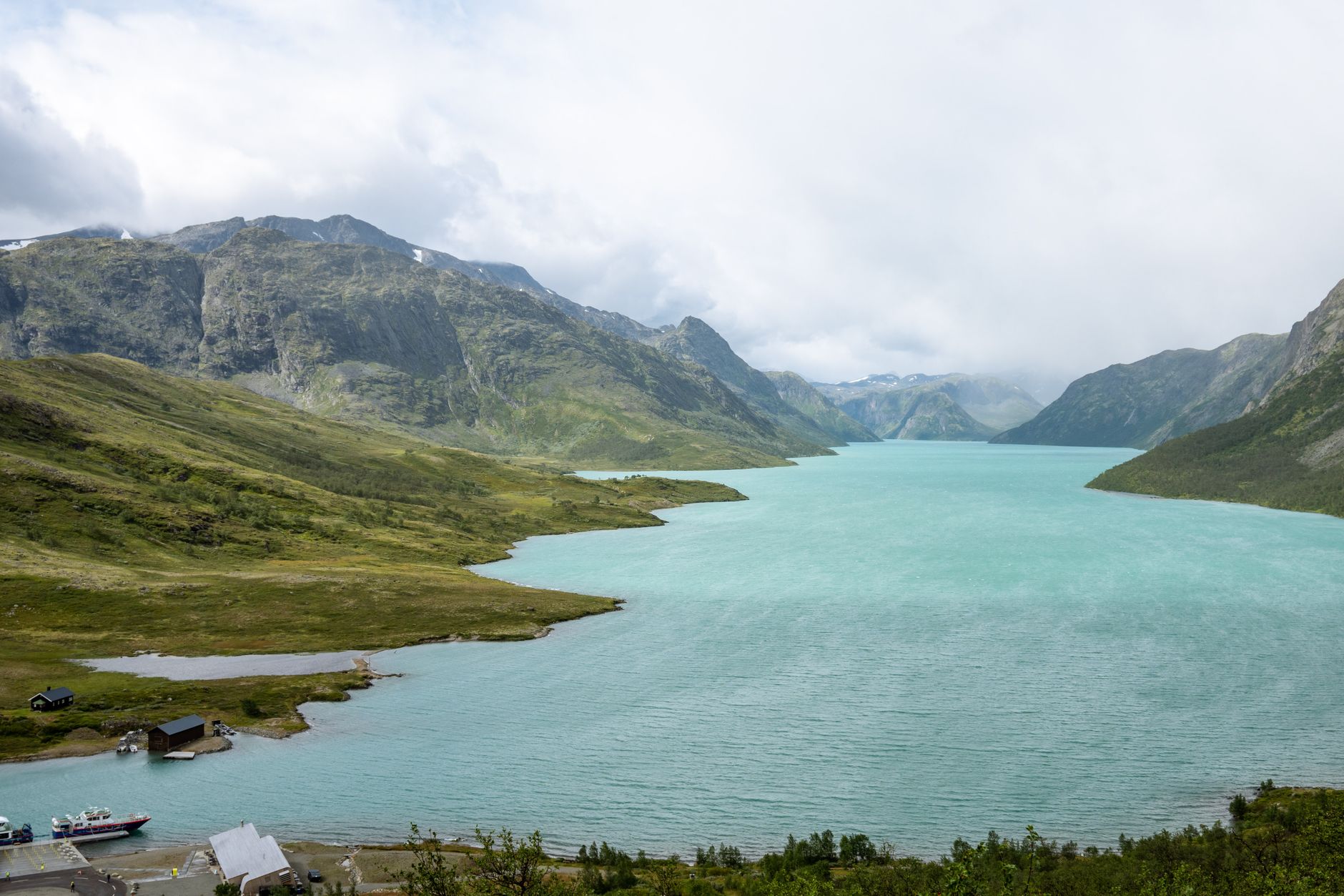 Beautiful panoramic view of turquoise lake surrounded by Jotunheimen mountains in Innlandet, Norway.