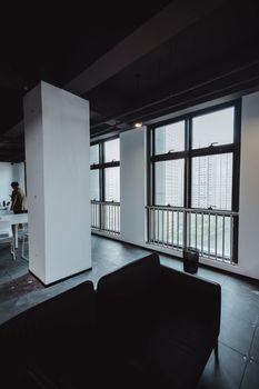 Spacious office space with large windows and modern furnishings.