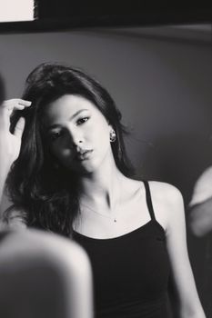 Classic black and white portrait of a woman with an introspective expression.