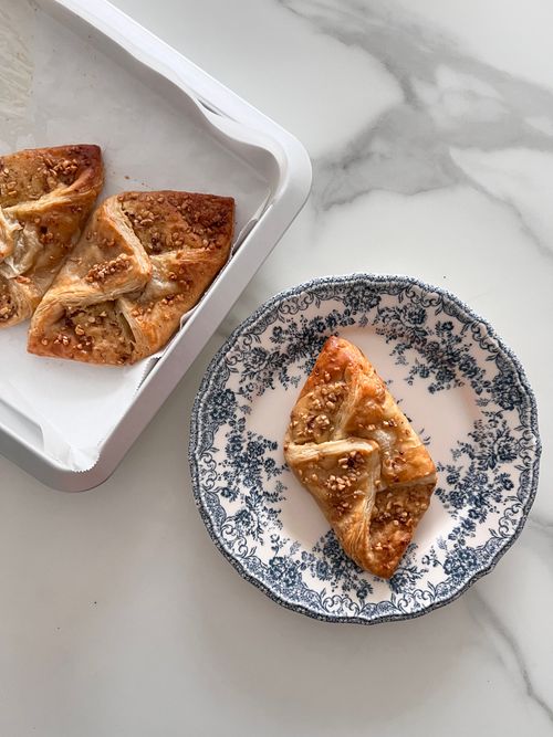 Free Top view of flaky pastries with nuts on elegant plate and baking tray, perfect for a sweet treat. Stock Photo