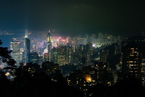 Free Beautiful illuminated skyline of Hong Kong city at night with towering skyscrapers and vibrant lights. Stock Photo
