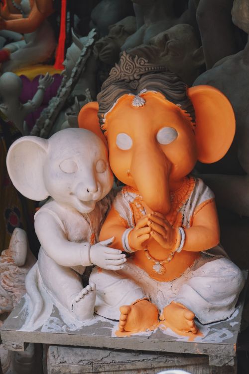 Free Colorful statues of Hindu deities in a workshop, showcasing traditional Indian craftsmanship. Stock Photo