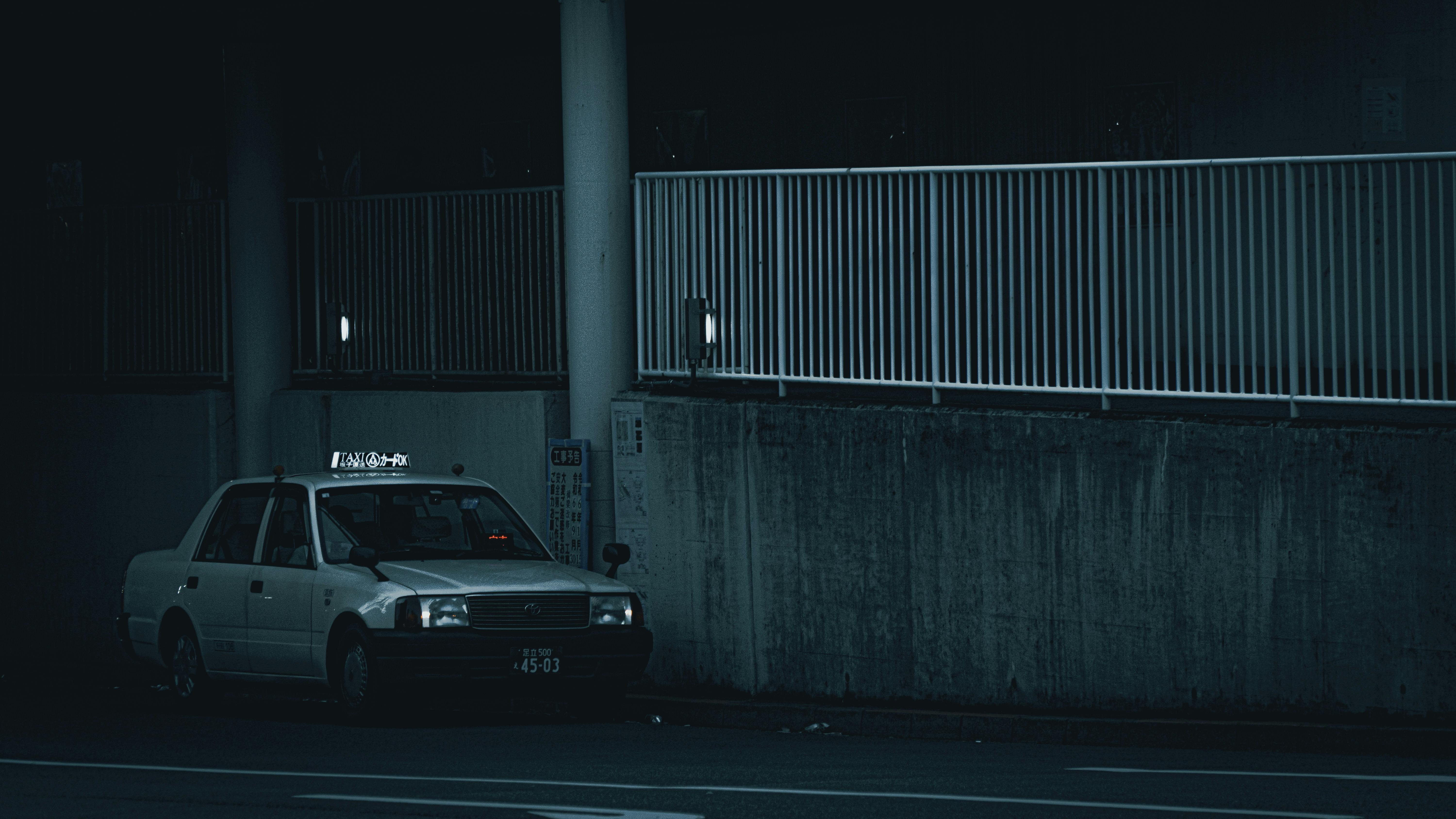 ingyenes Egy magányos taxi parkolt egy félhomályos városi területen éjszaka. Stockfotó