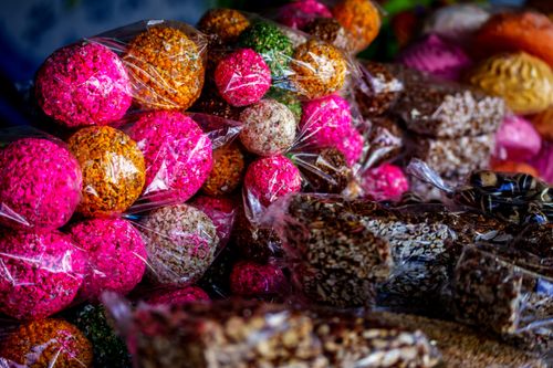 Free Colorful traditional Guatemalan sweets wrapped in plastic on display at a market in Ciudad de Guatemala. Stock Photo