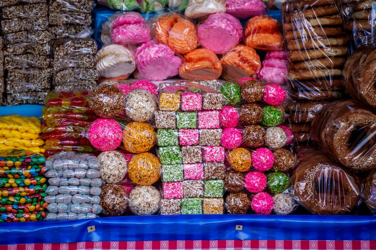 Vibrant display of traditional Guatemalan sweets at a market stall. Perfect for celebrating local culture.