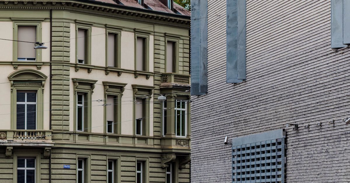 A juxtaposition of classic and modern architectural styles in an urban setting.