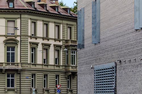 Free A juxtaposition of classic and modern architectural styles in an urban setting. Stock Photo