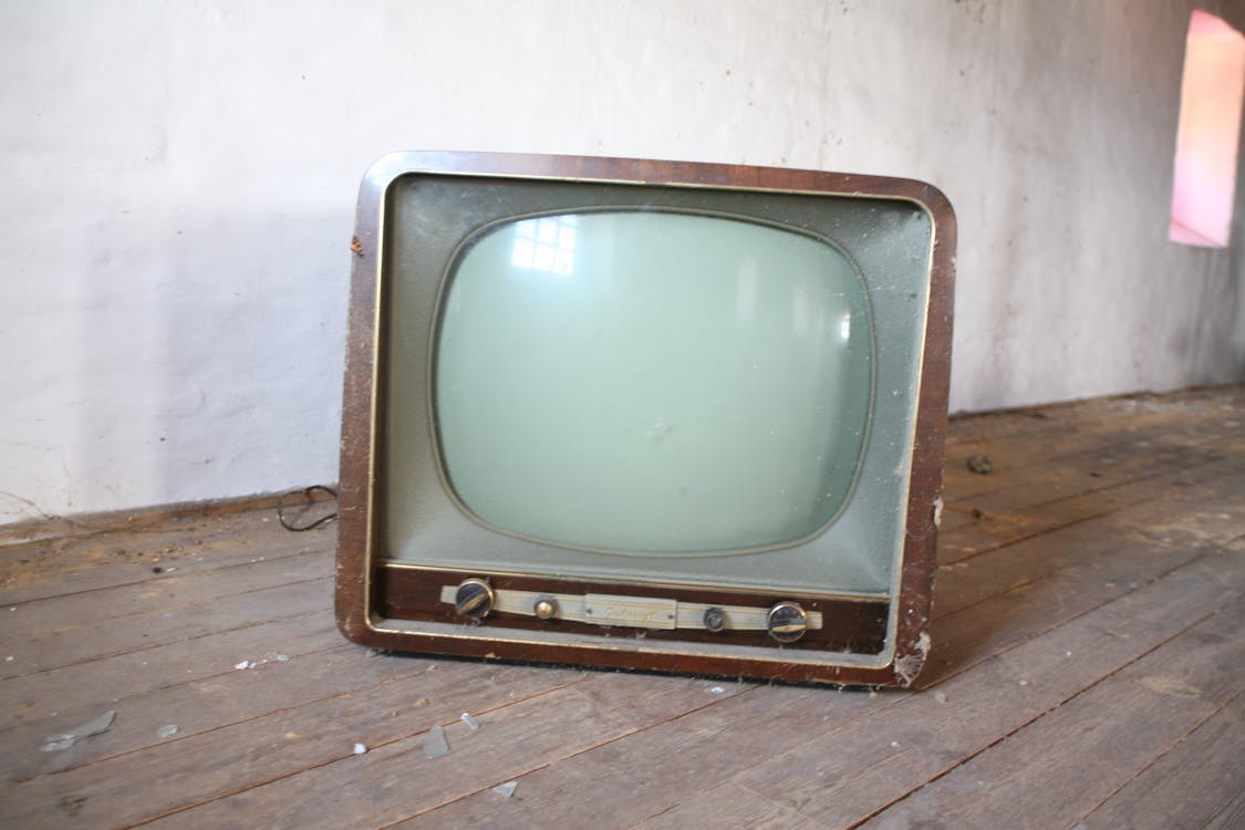 Free Vintage Brown Crt Tv on Parquet Wood Flooring Stock Photo