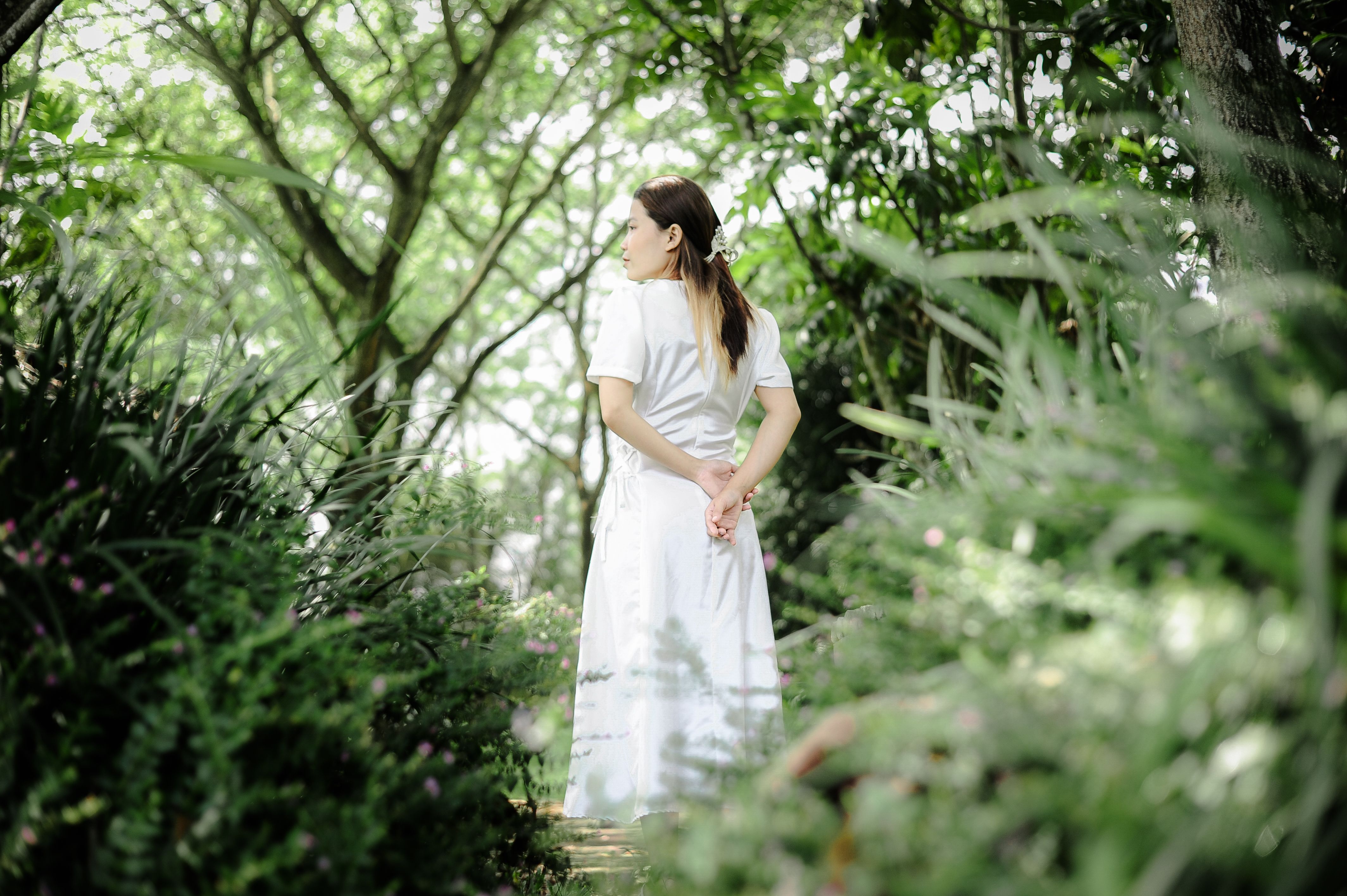 Woman in White Dress in Lush Green Forest · Free Stock Photo