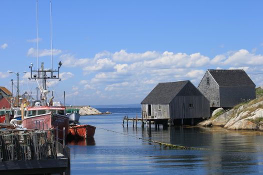 Picturesque fishing village at Peggy's Cove, Nova Scotia, with boats and rustic buildings by the water.