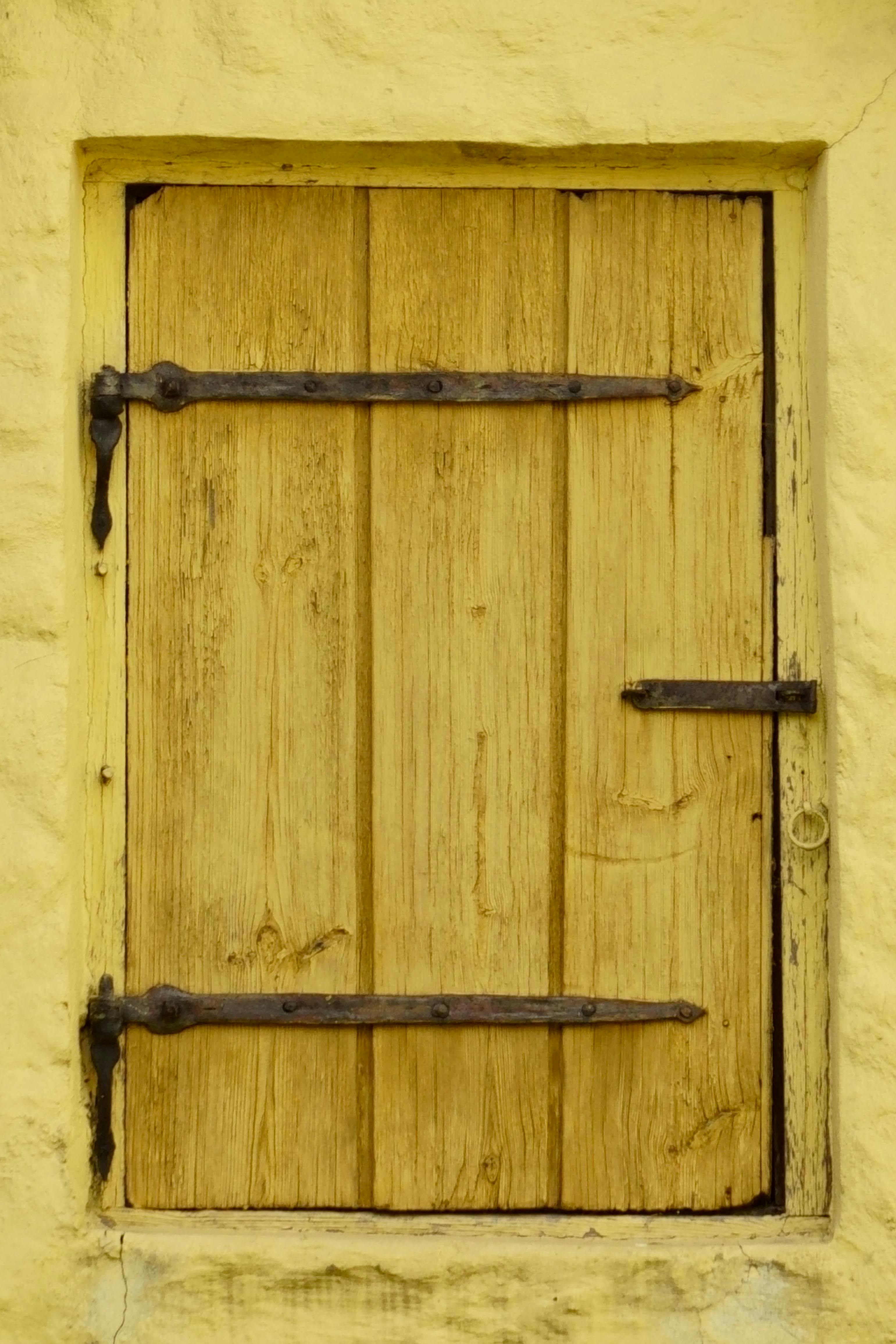 rustic wooden door with yellow frame