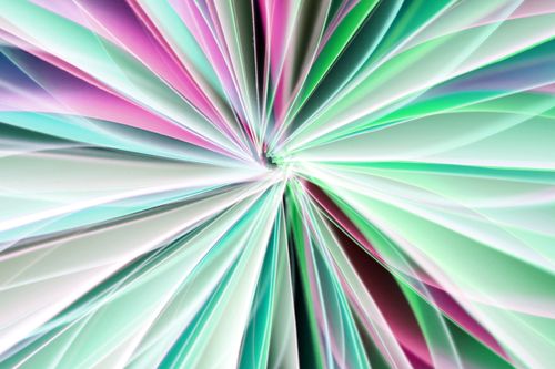 Free Vibrant abstract design featuring a radiant burst of multicolored light patterns in greens and pinks. Stock Photo