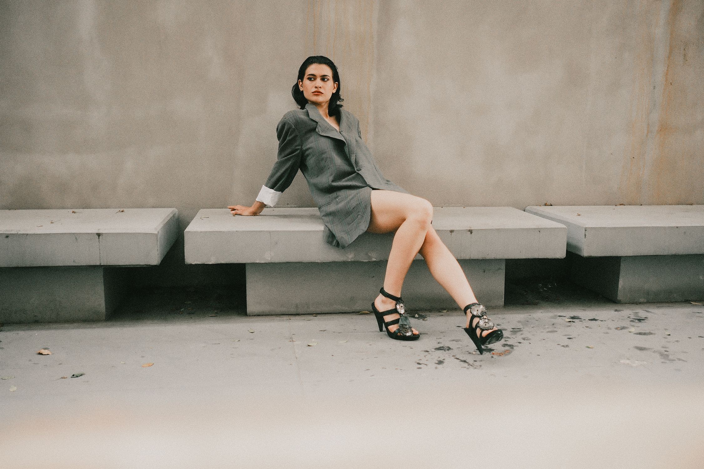Stylish Woman Sitting on Modern Concrete Bench · Free Stock Photo