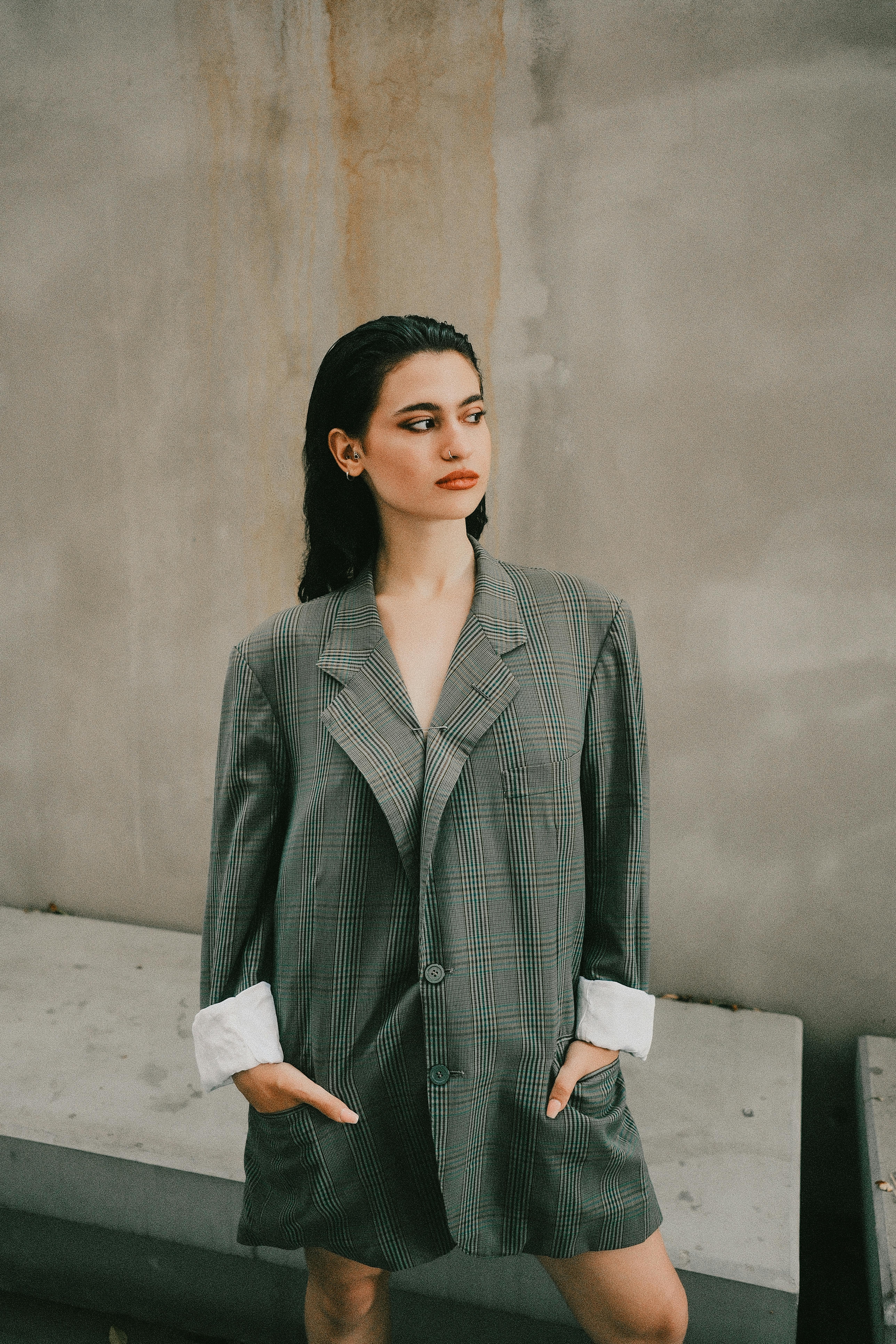 Stylish portrait of a woman wearing an oversized blazer, exuding confidence and elegance.