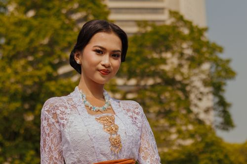 Free Portrait of a woman in traditional attire with intricate lace detail outdoors. Stock Photo
