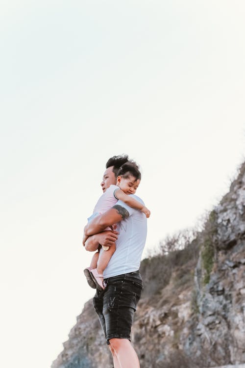 Free Man Carrying His Baby Stock Photo