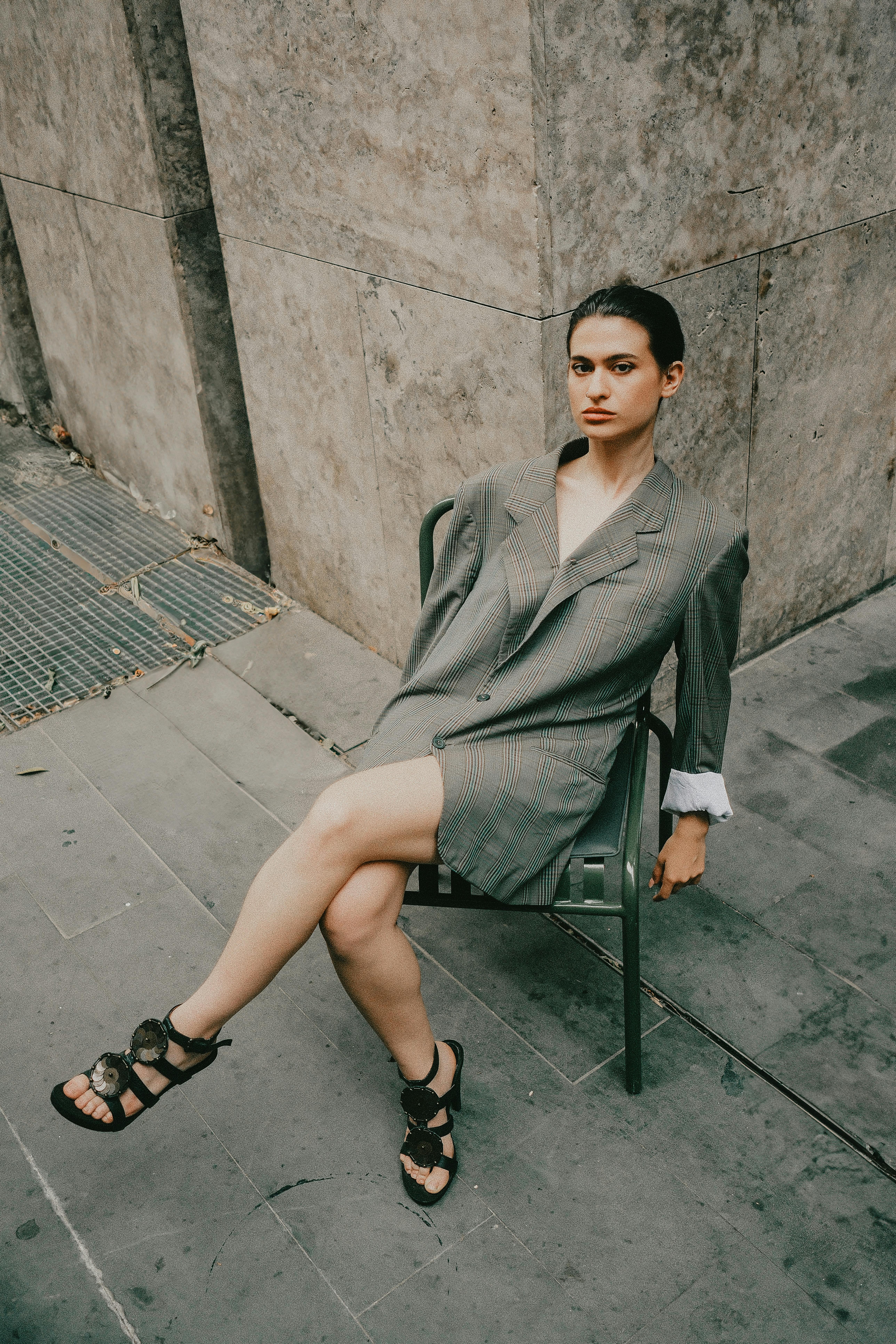 An oversized blazer and dark sunglasses do the quiet work that maximalist event dressing often cannot.