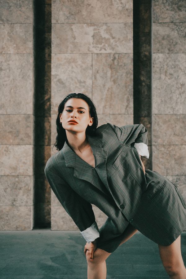 Woman wearing an oversized blazer over a dress