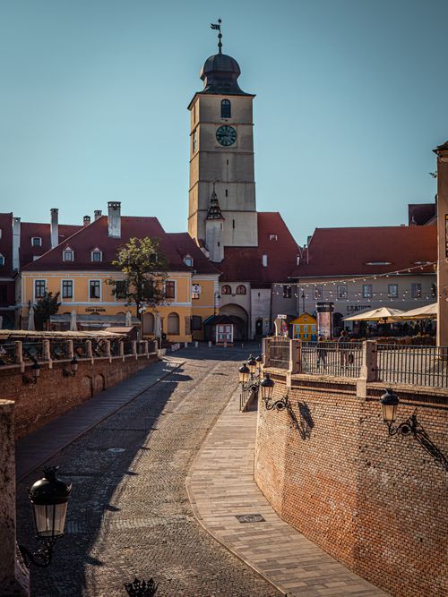 Free Explore the charm of Sibiu's historic architecture with this daylight view of its famous medieval tower. Stock Photo