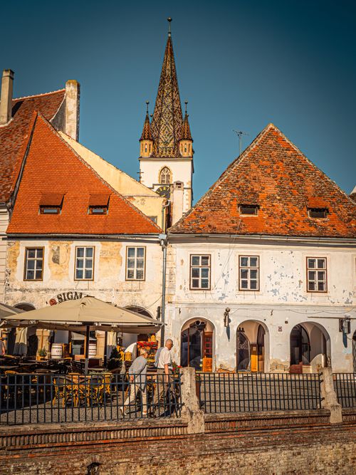 Free Charming street view of Sibiu, Romania showcasing historic architecture and a vibrant summer atmosphere. Stock Photo