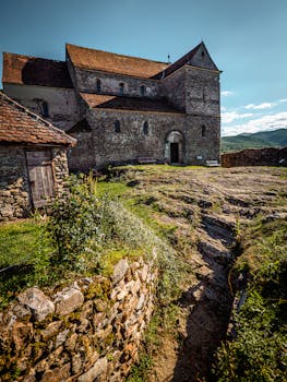 Explore the ancient architecture of a medieval fortified church in Sibiu, Romania, surrounded by serene landscapes.