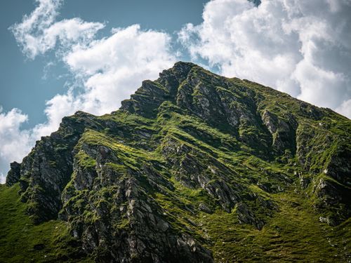 Free Dramatic view of a rocky mountain peak in Sibiu, Romania, under a vibrant blue sky. Stock Photo