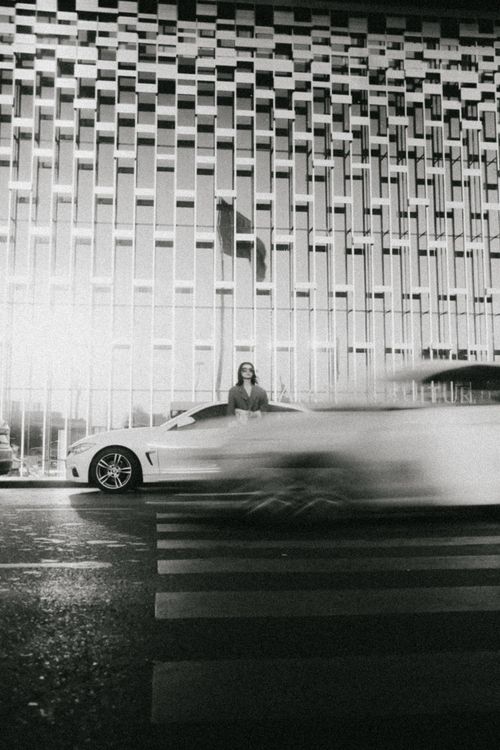 Free Dynamic city scene showcasing modern architecture and motion blur of passing cars. Stock Photo