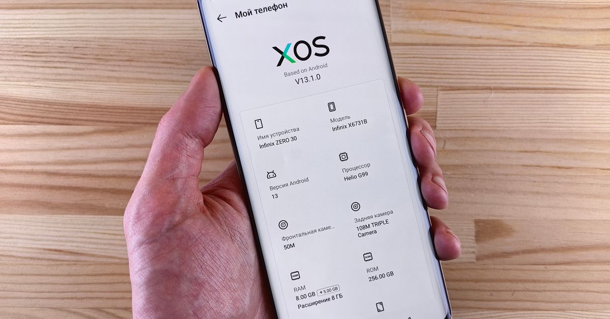 Hand Holding Smartphone with XOS Interface · Free Stock Photo
