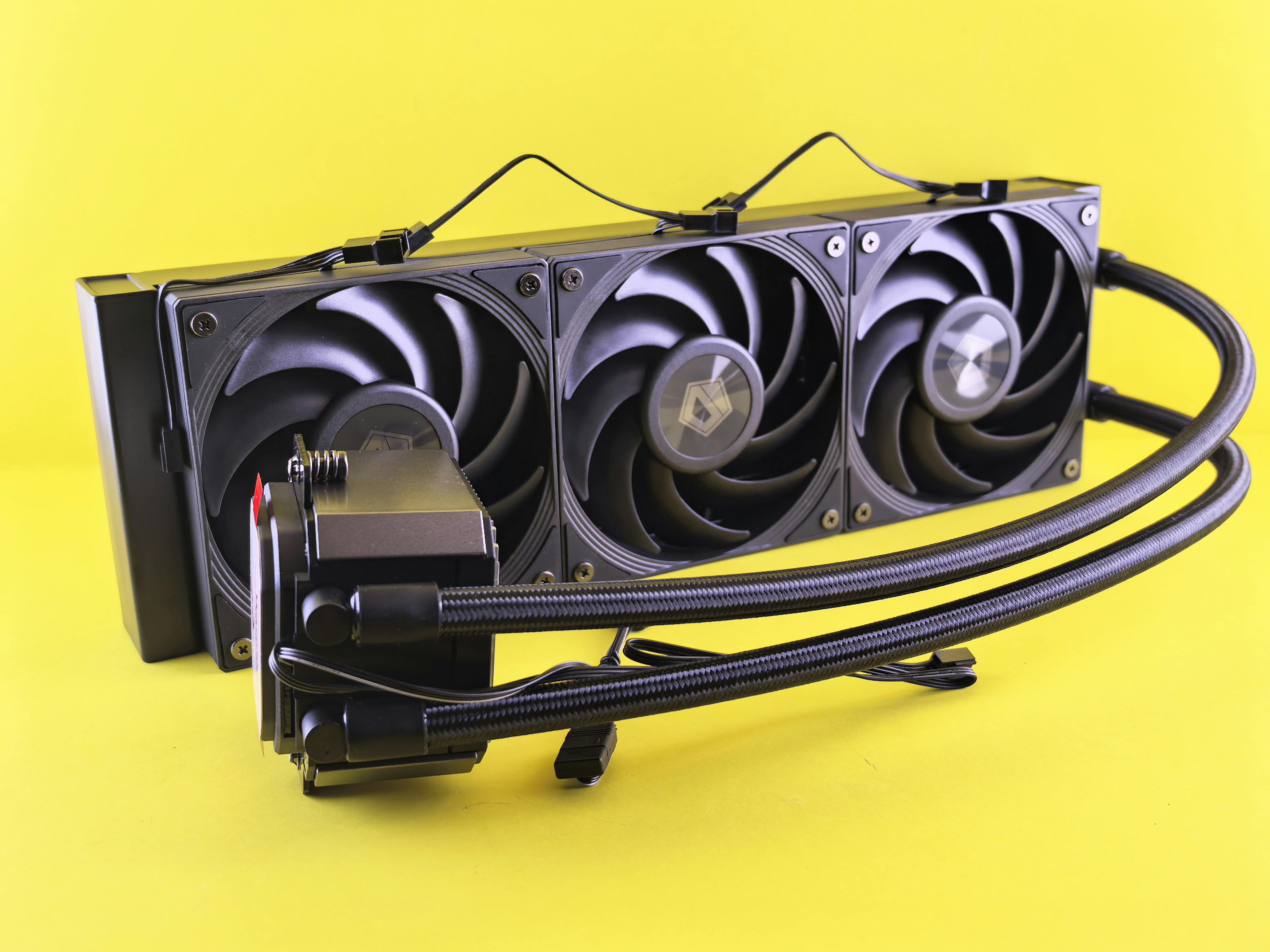 Triple fan liquid cooling system for efficient PC cooling on bright yellow background.