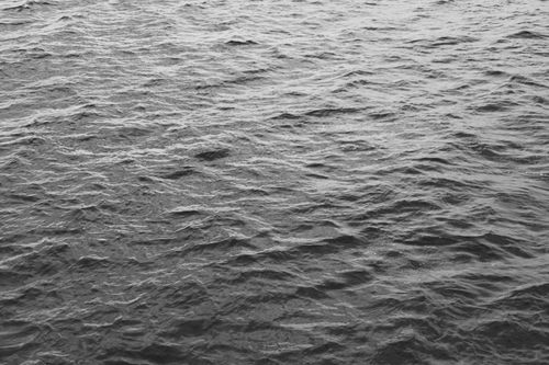 Free Calm and peaceful black and white photograph of ocean waves at Timmendorfer Strand in Germany. Stock Photo