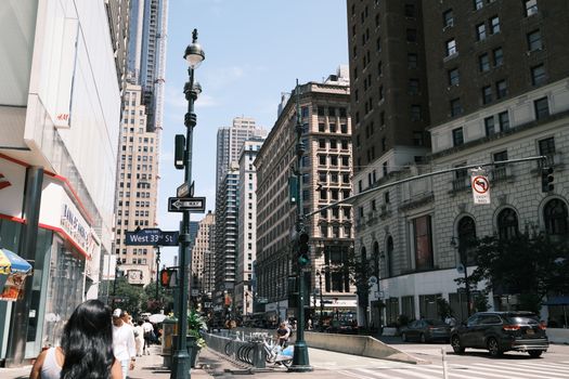 A vibrant view of West 33rd Street in New York City showcasing urban life and architecture.