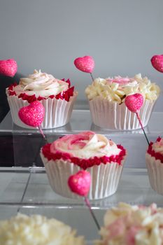 Delicious cupcakes adorned with pink heart decorations, perfect for celebrations.