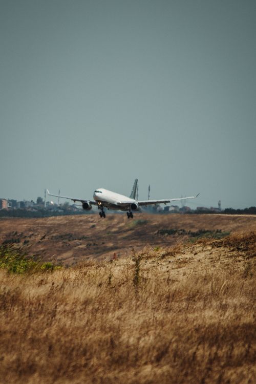 Free An Airbus A320 makes a landing on a sunny day in Istanbul, Türkiye, captured from a distance showing the cityscape. Stock Photo